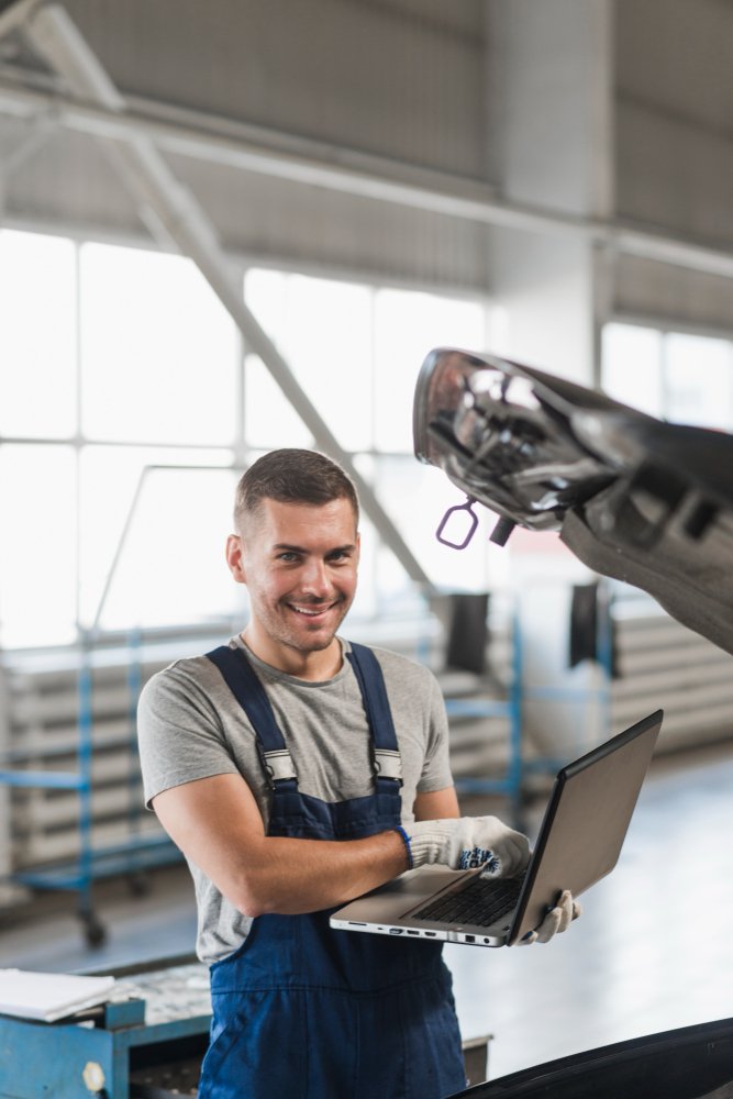 mechanic diagnosing using laptop
